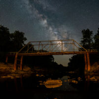 Taken July 20, 2022 at an abandoned bridge over Petit Jean River south of Magazine AR. Sony A7 iii with a Sony 20mm lens at f/1.8 for 15 seconds at ISO 3200 and one Lume Cube Go panel set at 1% several feet behind the camera to illuminate the bridge. This was 3 photos panned vertically to make this panoramic, which is actually more square. At this location it is very dark and looking south into an even darker sky. There were no lights other than my Lume Cube... I wished all night sky was this dark!